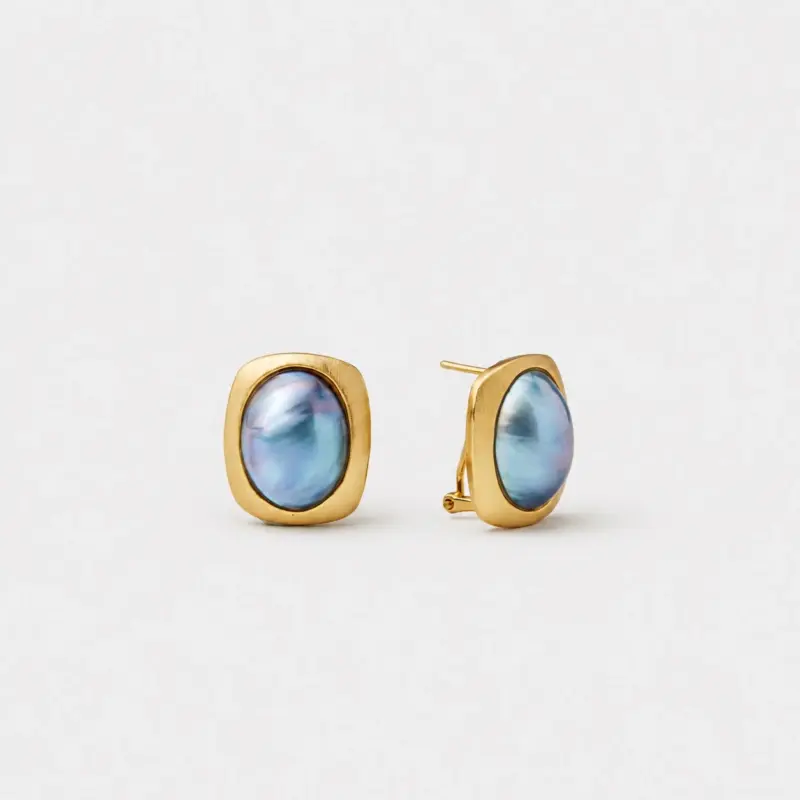 18K gold plated sterling silver mabe pearl stud earrings with a rounded square frame and iridescent blue-green, ocean blue, and subtle violet tones under varied light