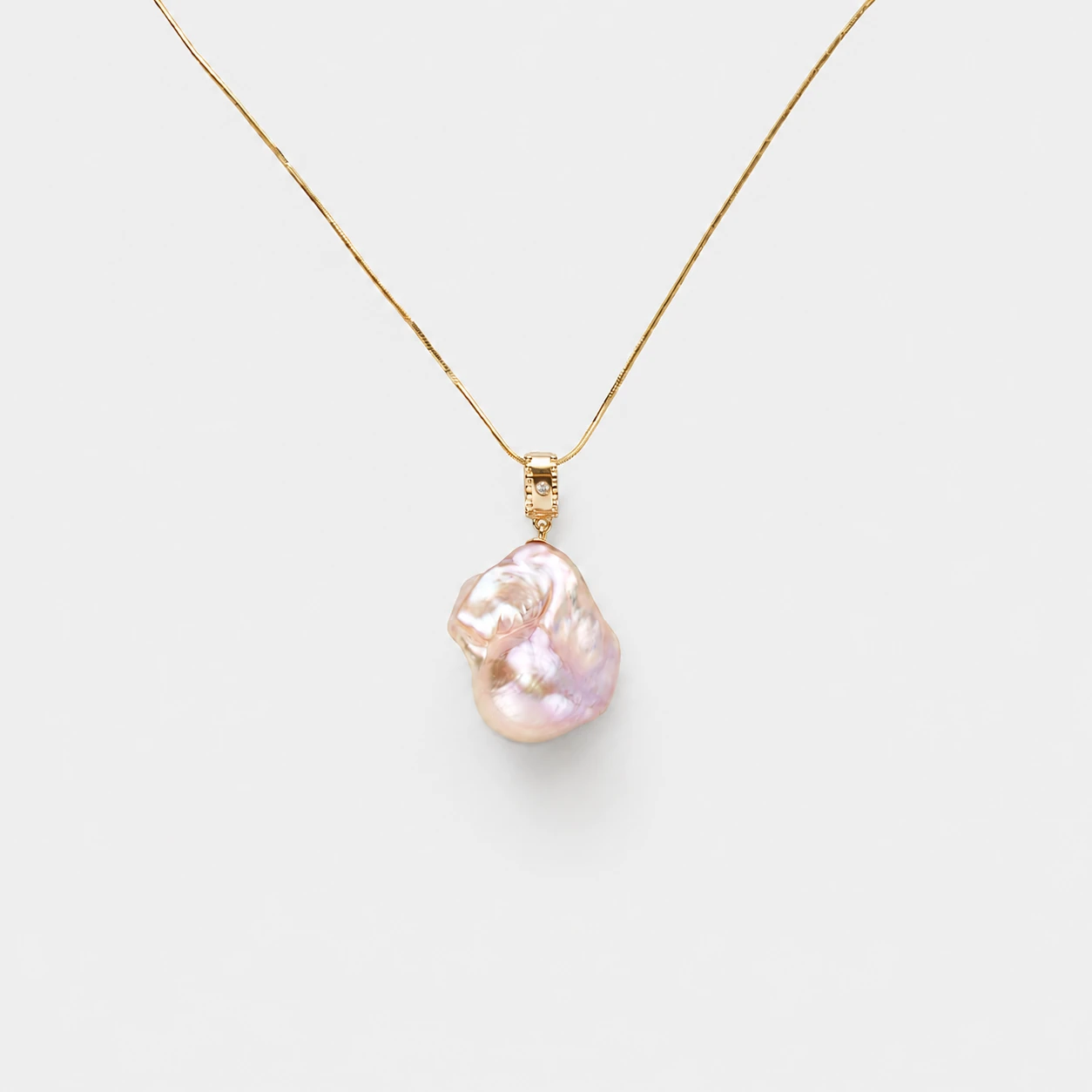 18k-gold-plated-sterling-silver-pink-baroque-pearl-necklace-minimalist-organic-drop 18K gold plated sterling silver pink baroque pearl necklace in a minimalist organic drop design