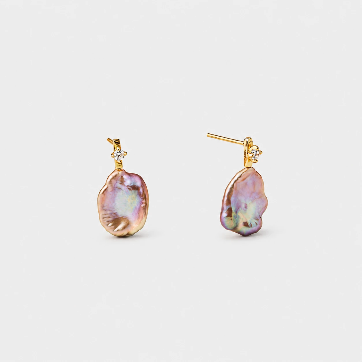 18k-gold-plated-sterling-silver-pink-baroque-pearl-stud-earrings-organic-petal 18K gold plated sterling silver pink baroque pearl stud earrings featuring a delicate prong-set cz stone and organic petal-shaped contours.