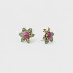 18K gold plated sterling silver ruby stud earrings featuring a floral shape with green pavé accents.