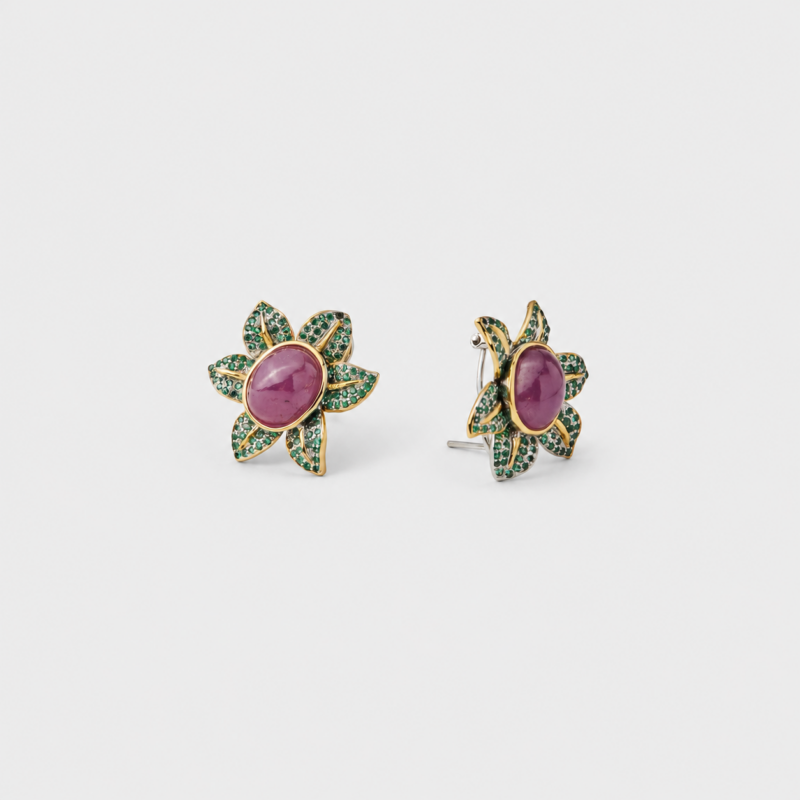 18K gold plated sterling silver ruby stud earrings featuring a floral shape with green pavé accents.