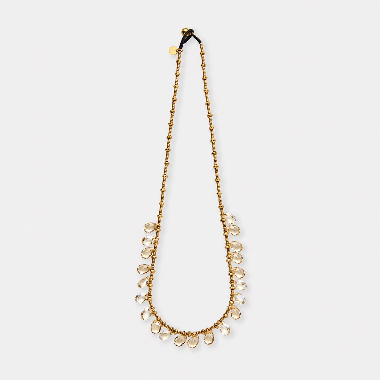 18k-gold-plated-titanium-steel-synthetic-quartz-drop-necklace-fringe-teardrop 18K gold plated titanium steel synthetic quartz drop necklace with a fringe teardrop design.