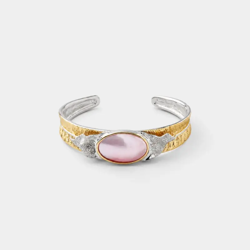 18K gold plated two-tone sterling silver mabe pearl cuff bracelet featuring a sculptural, open band design.