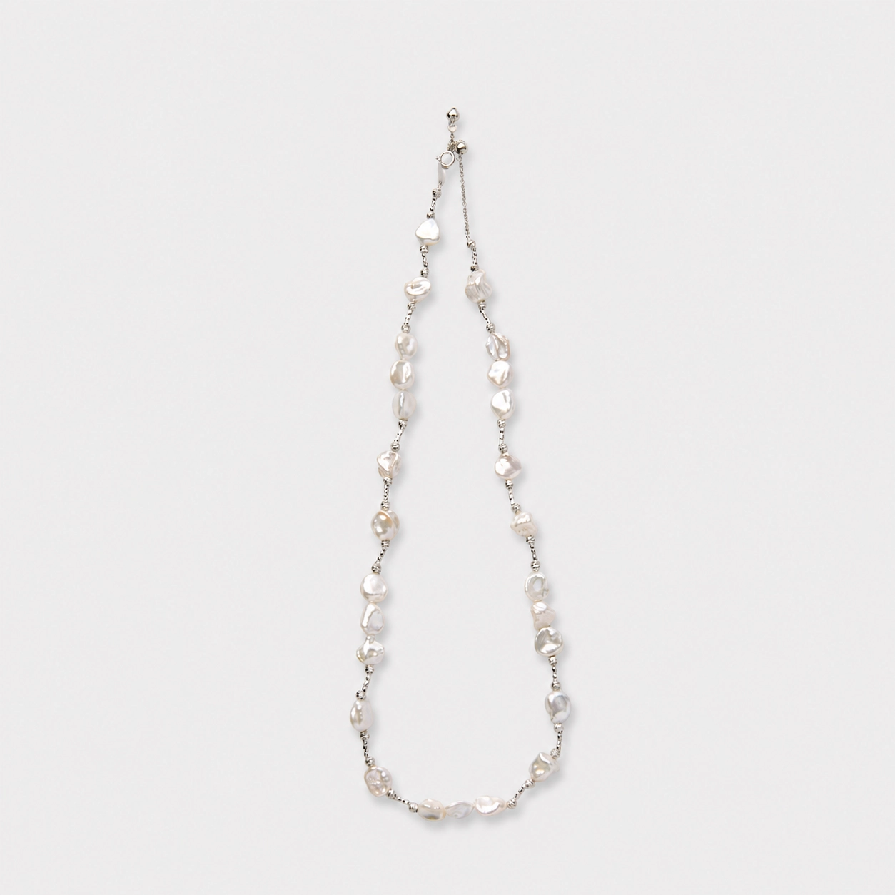 925-sterling-silver-petal-baroque-pearl-necklace-relaxed-asymmetry 925 sterling silver handcrafted petal baroque pearl necklace featuring a relaxed asymmetric design with natural soft luster