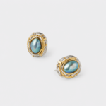Angled close-up view showing the textured two-tone accents and secure post backs of the mabe pearl stud earrings with premium gold and silver plating