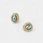 Angled close-up view showing the textured two-tone accents and secure post backs of the mabe pearl stud earrings with premium gold and silver plating