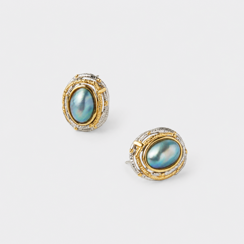 Angled close-up view showing the textured two-tone accents and secure post backs of the mabe pearl stud earrings with premium gold and silver plating