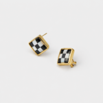 Angled detail view showing the checkerboard inlay of black agate and mother of pearl square stud earrings with an 18K gold plated frame.