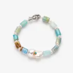 ONDA LENTA bracelet with blue-green gemstone beads, freshwater pearl accents and a sculptural baroque pearl centerpiece with a blue stone detail.