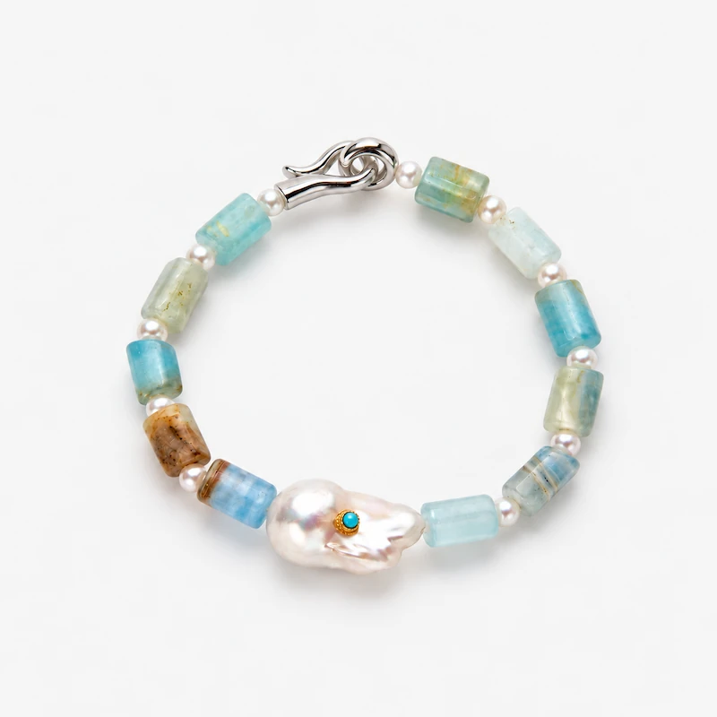ONDA LENTA bracelet with blue-green gemstone beads, freshwater pearl accents and a sculptural baroque pearl centerpiece with a blue stone detail.