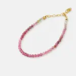Close-up detailed view highlighting the natural variation of pink and green faceted tourmaline beads on this strand bracelet finished with an 18K gold plated sterling silver adjustable chain
