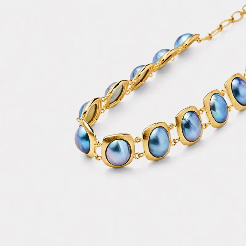 18K gold plated sterling silver blue mabe pearl necklace in a rhythmic oval collar layout