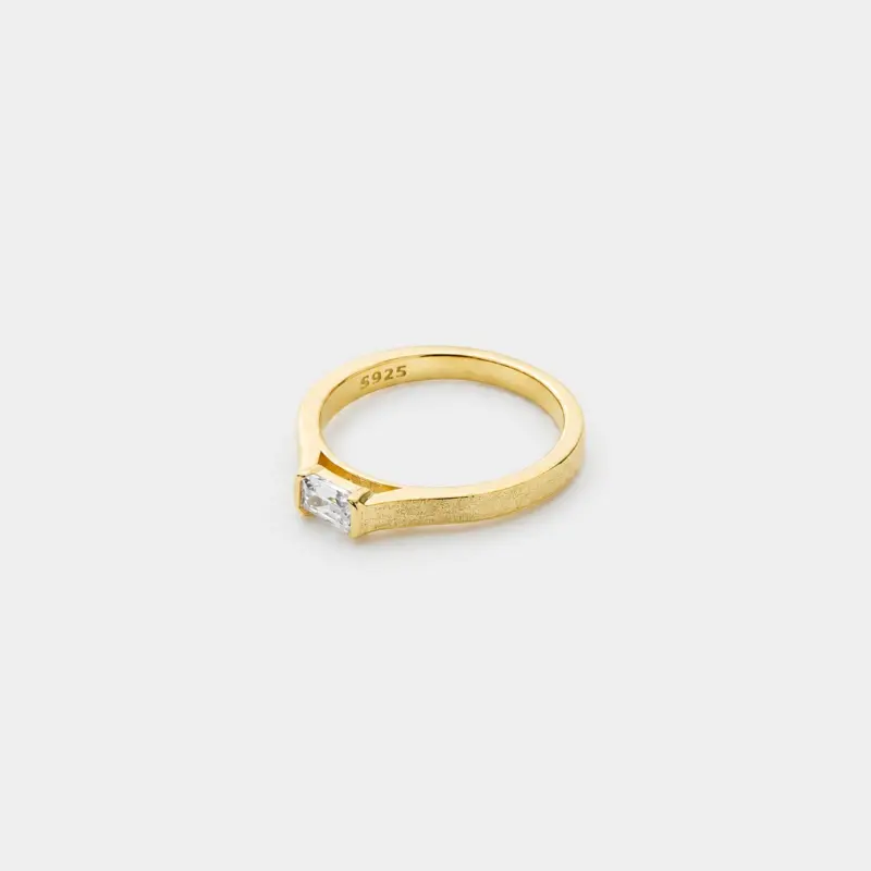 Close-up detail view of the low-profile rectangular zircon and softly textured band on this minimal ring crafted in 18K gold plated sterling silver