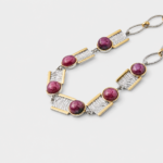 Close-up detail view showing the handcrafted wavy textures on the rectangular silver panels of the gemstone bracelet framed by polished gold borders.