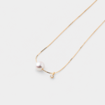 Detailed close-up displaying the flawless single pearl and the small, precisely-set cubic zirconia charm on a fine 14K Gold Vermeil chain, highlighting the polished finish and sparkle.