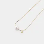 An elegant and polished 14K Gold Vermeil necklace with a singular, lustrous white pearl and a tiny sparkling cubic zirconia charm, perfect for achieving a refined, everyday look.