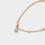 Close-up detail view showcasing the shimmering zircon charm and delicate bead chain links of the Shimmer bracelet crafted with high-polish 18k gold plating over sterling silver