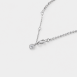 Close-up detail view of the shimmering silver-white zircon charm and fine bead links on this delicate chain bracelet crafted in rhodium plated sterling silver