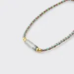 Close-up detailed view of the textured woven braided cord and smooth gradient green chalcedony beads on the focal strand bracelet with 18K gold plated sterling silver accents