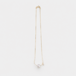 An elegant and polished 14K Gold Vermeil necklace with a singular, lustrous white pearl and a tiny sparkling cubic zirconia charm, perfect for achieving a refined, everyday look.