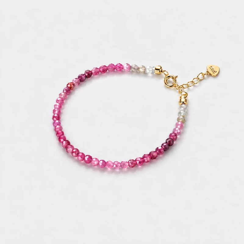 Close-up view of an ONDA LENTA bracelet with faceted pink tourmaline beads in naturally varied pink and pale tones.