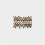 Front view showing the intricate beaded mesh pattern of the wide textile cuff bracelet accented with clustered golden beads and a smooth shell clasp.