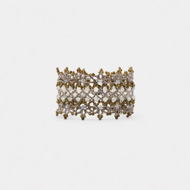 Front view showing the intricate beaded mesh pattern of the wide textile cuff bracelet accented with clustered golden beads and a smooth shell clasp.