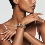 Model wearing Abalone Shell Cuff Bracelet with sculptural gold details around her wrist for a bold artistic statement