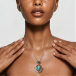 Model wearing Abalone Shell Pendant with shifting vibrant coastal colors around her neckline to refresh a basic casual look