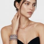 Model wearing Aura Drop Necklace gracefully at the neckline.