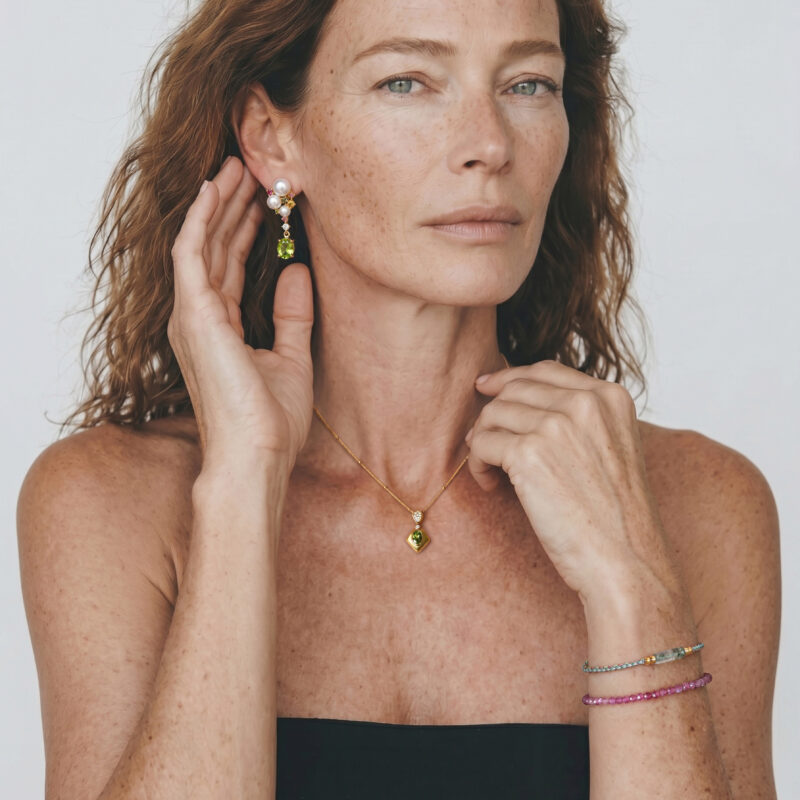 Model wearing Blooming Banquet peridot pearl drop earrings with joyful gemstone clusters on her ears for graceful everyday outfit styling