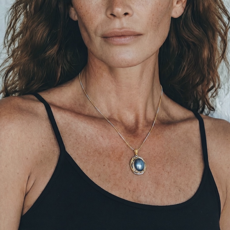 Model wearing Blue Mabe Pearl Pendant with a calm ocean-like glow around her neckline for an elegant workwear style
