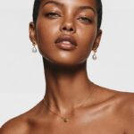 Model wearing the delicate Dot Peridot necklace resting elegantly on her collarbone for effortless everyday styling