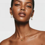 Model wearing the delicate Dot Peridot necklace resting elegantly on her collarbone for effortless everyday styling