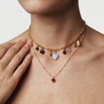 Model wearing Luna Charms Necklace layered gracefully at the neckline.