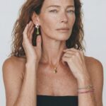 Model wearing the Green Chalcedony Bracelet featuring gradient gemstone beads and a soft braided cord elegantly stacked on her wrist for a relaxed everyday casual look