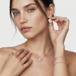 Model wearing the Baroque Pearl Stud Earrings featuring naturally irregular pink pearls and shimmering zircon details on her ears for elegant daily styling