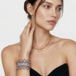 Model wearing Secret Garden Woven Bracelet on her wrist paired with a delicate gold drop necklace for elegant everyday styling.