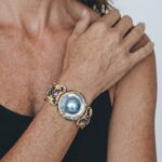 Model wearing Sun Shell Diamond Bracelet with soft ocean-like iridescence around her wrist for elegant dinner styling