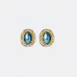ONDA LENTA oval abalone shell earrings featuring iridescent blue-green shell centers and textured two-tone gold and silver settings.
