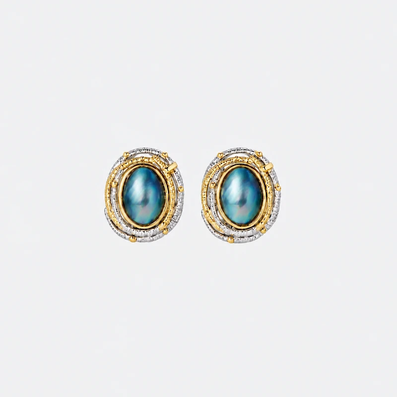 ONDA LENTA oval abalone shell earrings featuring iridescent blue-green shell centers and textured two-tone gold and silver settings.