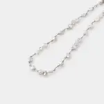 etailed close-up view of organic petal baroque pearls linked meticulously with clean 925 sterling silver chain links