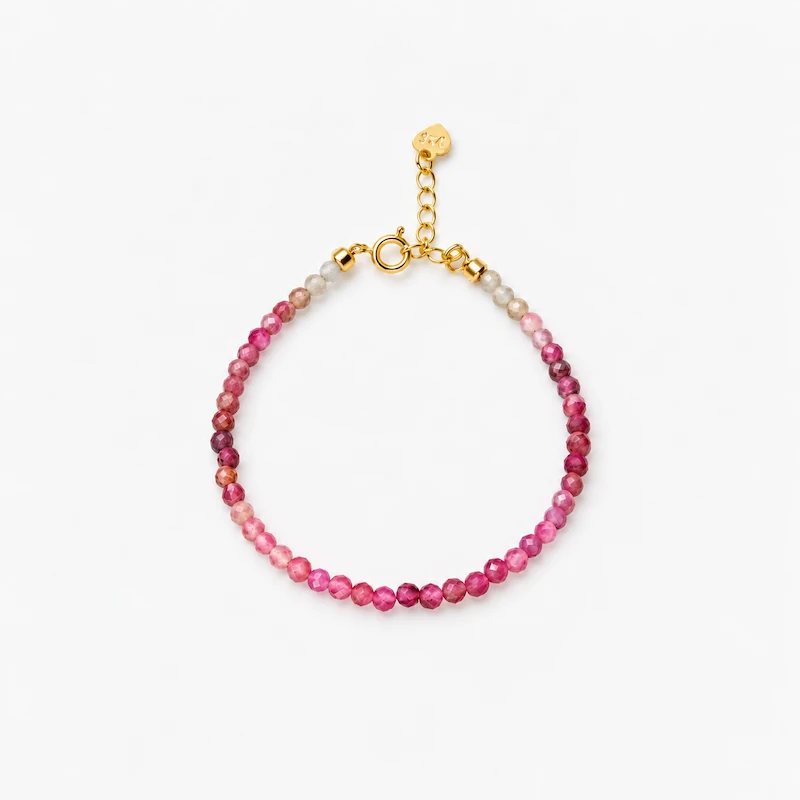 ONDA LENTA pink tourmaline beaded bracelet featuring faceted gradient stones and an adjustable gold-tone extension chain.