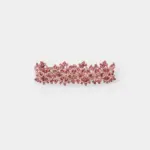 Side view showing the intricate openwork lace pattern woven with red garnet beads onto a flexible palladium plated metal frame.