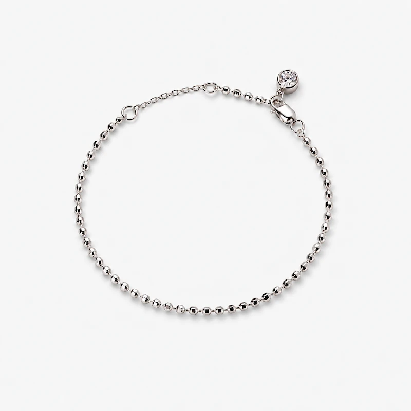 ONDA LENTA silver beaded chain bracelet with a clear round stone charm, lobster clasp and adjustable extension chain.
