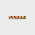 Horizontal flat lay view of vineyard woven gold bracelet showcasing detailed gemstone rows of green peridot and red garnet beads