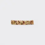 Horizontal flat lay view of vineyard woven gold bracelet showcasing detailed gemstone rows of green peridot and red garnet beads