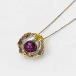 ONDA LENTA BAOLIAN Ruby Peridot Pendant featuring a purple-red ruby centerpiece, green peridot, and sculptural two-tone floral metalwork