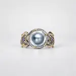 ONDA LENTA baroque pearl cuff bracelet featuring a large oval pearl centerpiece, two-tone gold and silver openwork design, and gemstone details.