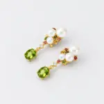 ONDA LENTA pearl drop earrings with oval green gemstones, white pearls and multicolor gemstone accents in a gold setting.